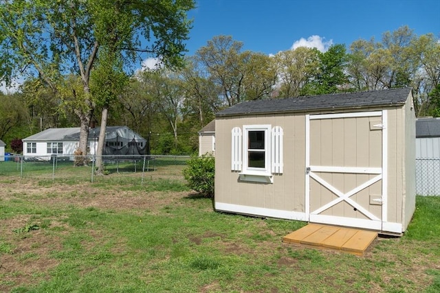 view of shed featuring view of wooded area