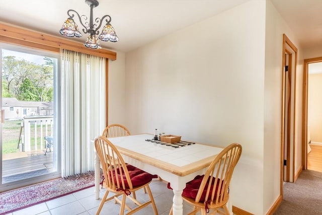 dining room featuring plenty of natural light, a chandelier, and baseboards