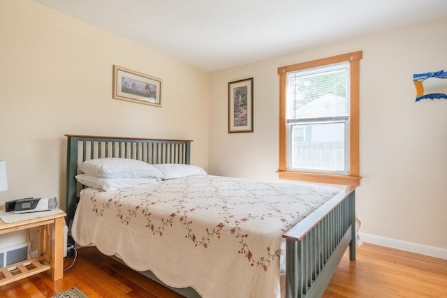 bedroom with wood finished floors and baseboards
