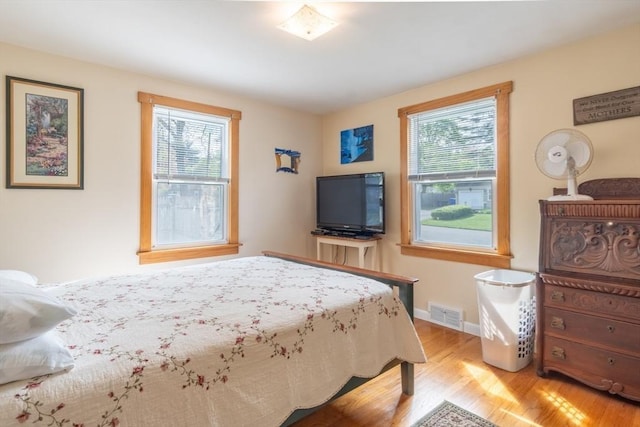 bedroom featuring light wood-style flooring and baseboards