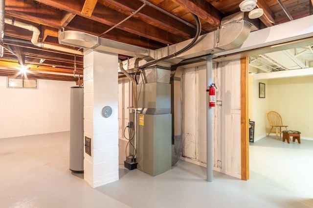 unfinished below grade area featuring heating unit and water heater