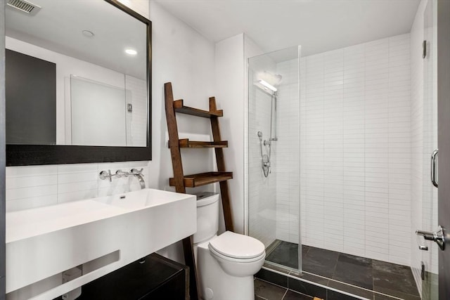 full bathroom with a stall shower, visible vents, vanity, and toilet