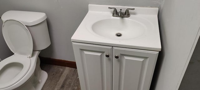107 Chestnut Cir, Randolph, MA 02368 - half bathroom featuring toilet, vanity, wood finished floors, and baseboards