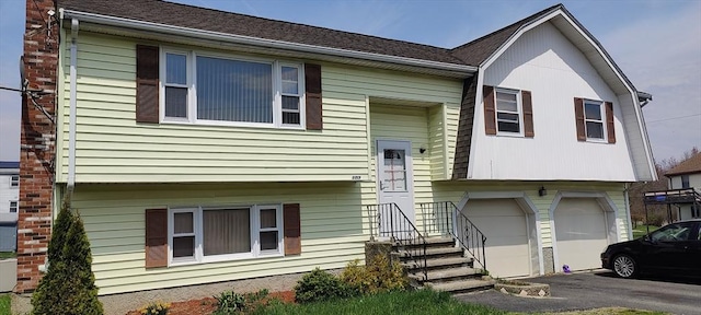 107 Chestnut Cir, Randolph, MA 02368 - view of front facade with asphalt driveway and a garage