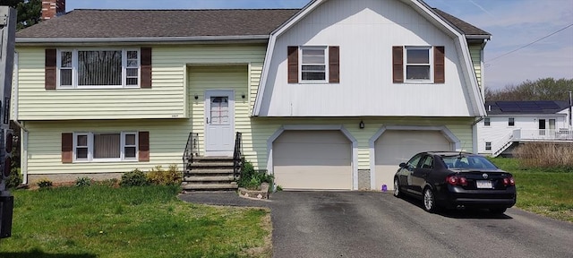107 Chestnut Cir, Randolph, MA 02368 - bi-level home with a garage, driveway, a chimney, entry steps, and a front yard