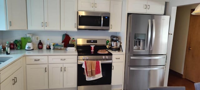 107 Chestnut Cir, Randolph, MA 02368 - kitchen featuring appliances with stainless steel finishes, light countertops, and white cabinets
