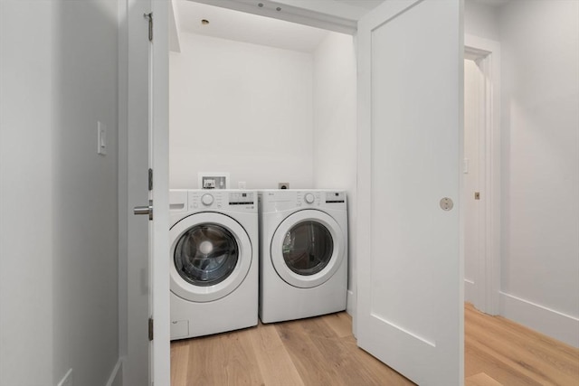 2202 Commonwealth Ave Unit 3, Newton, MA 02466 - washroom with washing machine and clothes dryer and light wood-style floors