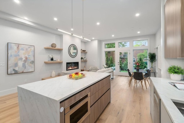 2202 Commonwealth Ave Unit 3, Newton, MA 02466 - kitchen with modern cabinets, appliances with stainless steel finishes, light wood finished floors, recessed lighting, and a center island