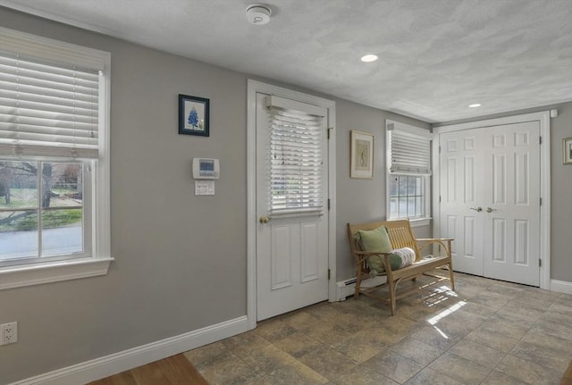 interior space featuring baseboards and recessed lighting