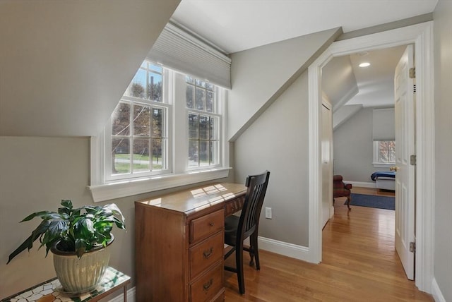 office space with light wood-style floors, recessed lighting, baseboards, and vaulted ceiling