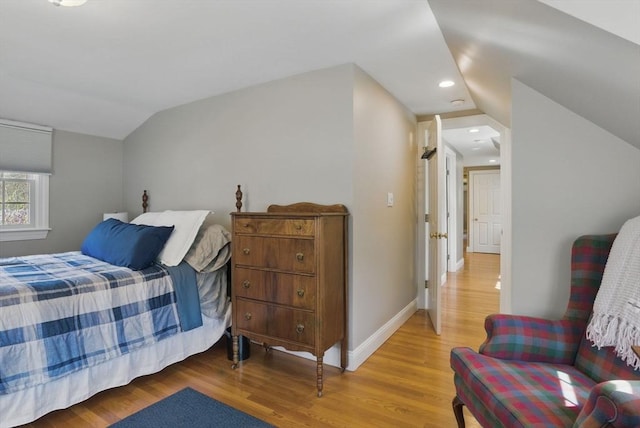 bedroom with baseboards, vaulted ceiling, recessed lighting, and wood finished floors
