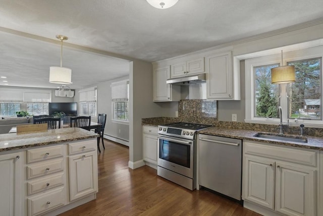 kitchen with a sink, plenty of natural light, baseboard heating, and stainless steel appliances
