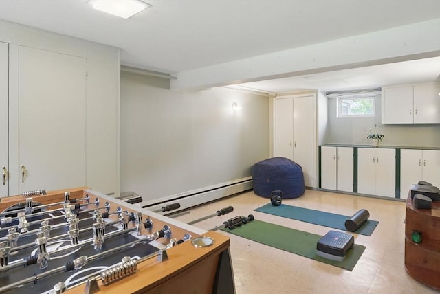 playroom featuring a baseboard heating unit