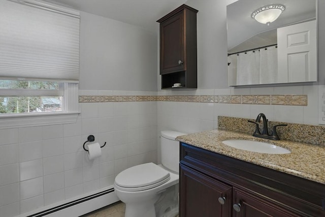 bathroom featuring vanity, tile patterned flooring, toilet, tile walls, and a baseboard radiator