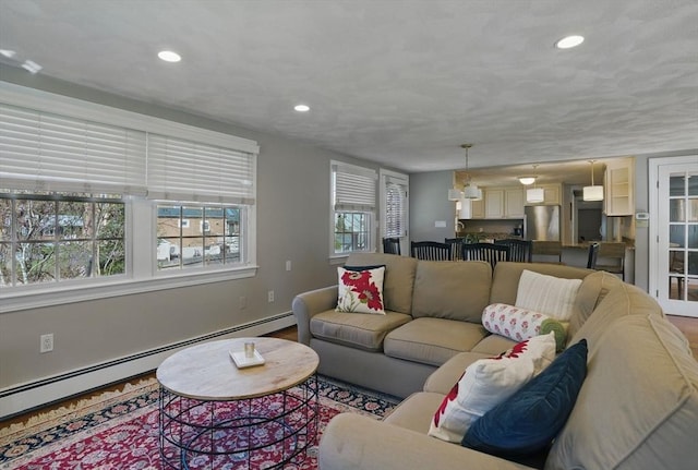 living room with recessed lighting and a baseboard radiator