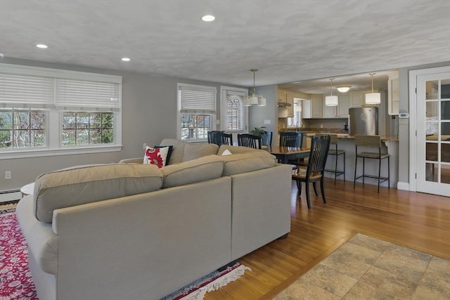 living area featuring a healthy amount of sunlight, recessed lighting, and wood finished floors