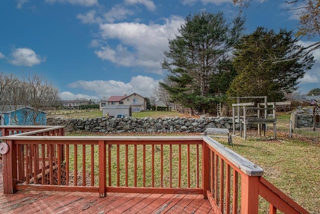 wooden terrace featuring a yard