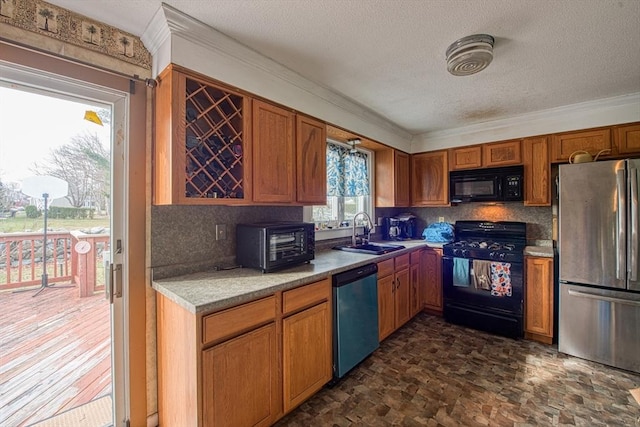 kitchen featuring black appliances, backsplash, ornamental molding, and sink