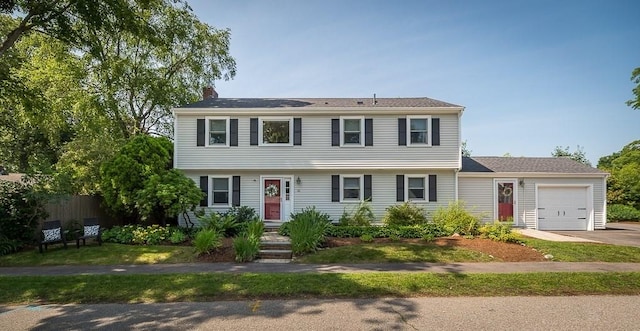 31 Orchard Rd, Hamilton, MA 01982 - colonial home featuring a garage, a chimney, and concrete driveway