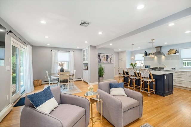 31 Orchard Rd, Hamilton, MA 01982 - living room with a baseboard radiator, recessed lighting, and light wood-type flooring
