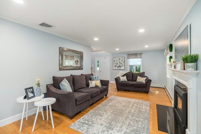 31 Orchard Rd, Hamilton, MA 01982 - living room featuring ornamental molding, light wood-type flooring, recessed lighting, a fireplace with flush hearth, and a baseboard radiator