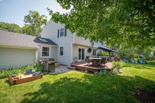 31 Orchard Rd, Hamilton, MA 01982 - rear view of house with a wooden deck, a yard, outdoor dining area, roof with shingles, and a vegetable garden