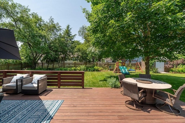 31 Orchard Rd, Hamilton, MA 01982 - wooden terrace featuring a playground, a fenced backyard, outdoor dining area, and an outbuilding