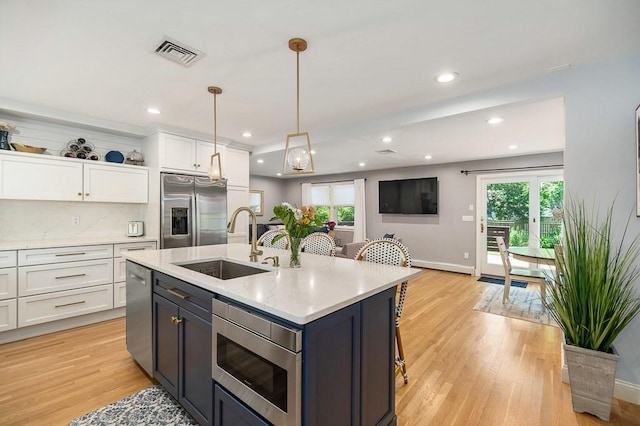 31 Orchard Rd, Hamilton, MA 01982 - kitchen with stainless steel appliances, light countertops, healthy amount of natural light, white cabinetry, and recessed lighting
