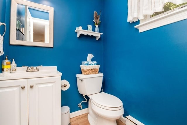 3 Beals Cv Unit F, Hingham, MA 02043 - half bath featuring toilet, vanity, baseboards, wood finished floors, and baseboard heating
