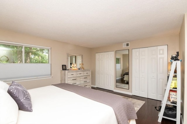3 Beals Cv Unit F, Hingham, MA 02043 - bedroom featuring two closets, wood finished floors, a textured ceiling, and baseboards