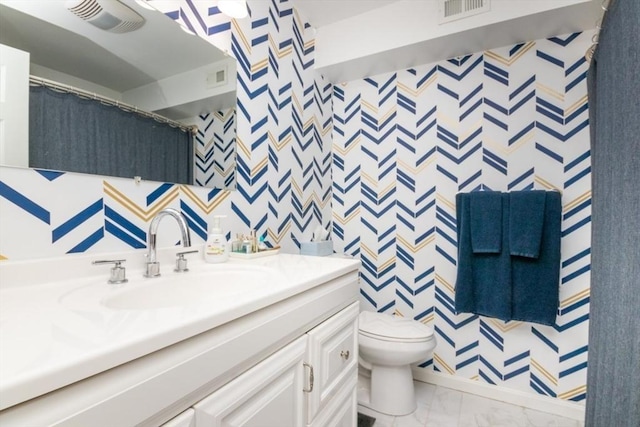 3 Beals Cv Unit F, Hingham, MA 02043 - bathroom with wallpapered walls, vanity, marble finish flooring, and toilet