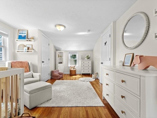 17 Clifton Ave, Scituate, MA 02066 - bedroom featuring multiple windows, wood finished floors, and a nursery area