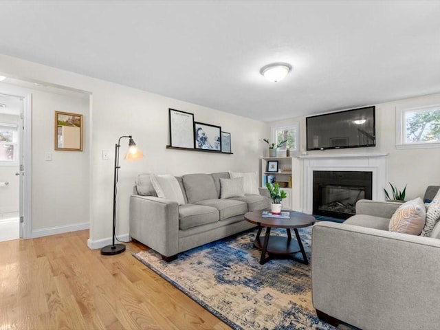 17 Clifton Ave, Scituate, MA 02066 - living room with light wood-style floors and a glass covered fireplace