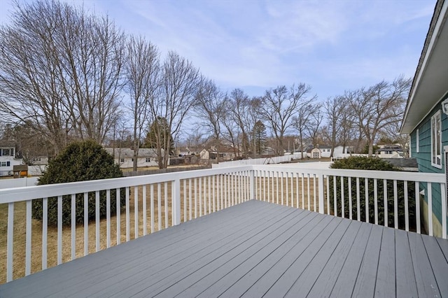 wooden terrace with a residential view and fence