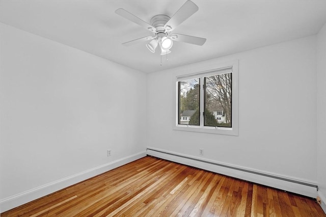 empty room with ceiling fan, baseboards, baseboard heating, and hardwood / wood-style floors