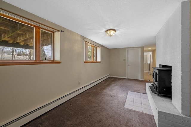 unfurnished living room with baseboard heating, carpet flooring, and a textured ceiling