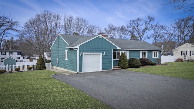 view of front of house featuring a front yard, fence, driveway, a chimney, and a garage