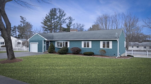 ranch-style home with fence, driveway, an attached garage, a chimney, and a front lawn