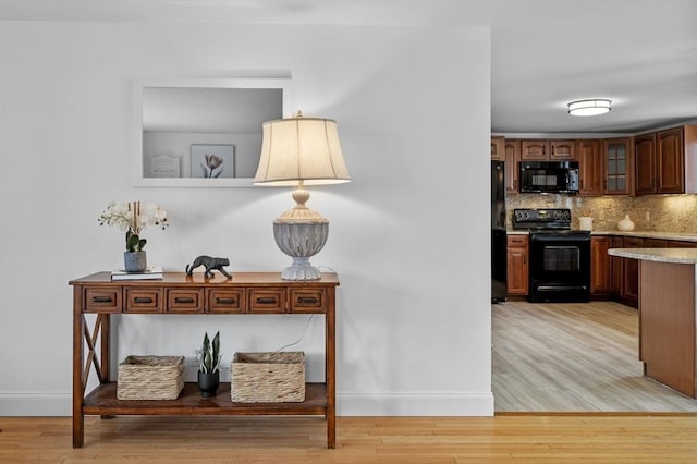 interior space with baseboards and light wood-style floors