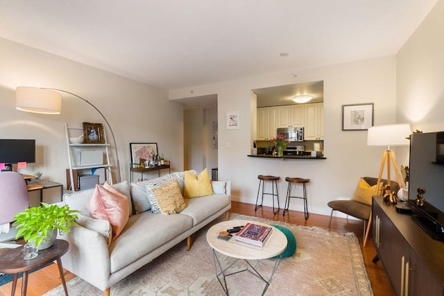 living area with wood finished floors and baseboards
