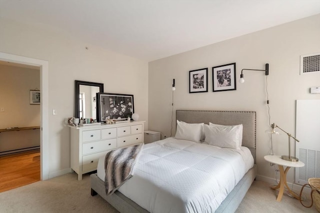 bedroom featuring light colored carpet and baseboards