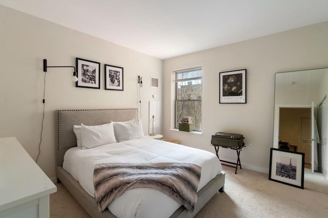 bedroom with light carpet and baseboards