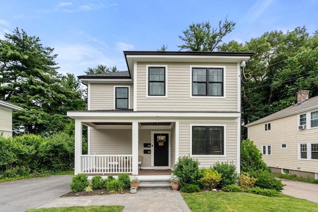 103 Warwick Rd Unit 103, Newton, MA 02465 - view of front of house with a porch and asphalt driveway