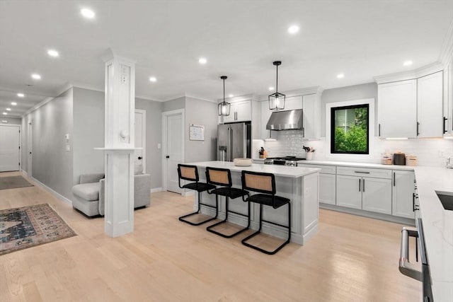103 Warwick Rd Unit 103, Newton, MA 02465 - kitchen with stainless steel fridge, range hood, backsplash, recessed lighting, and light wood-style flooring