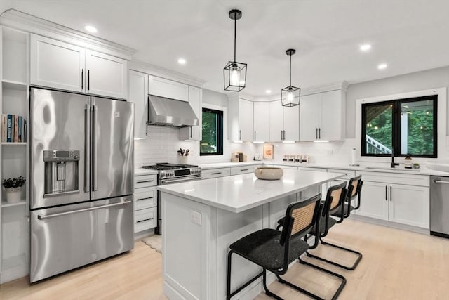 103 Warwick Rd Unit 103, Newton, MA 02465 - kitchen featuring stainless steel appliances, wall chimney exhaust hood, plenty of natural light, light wood-type flooring, and recessed lighting