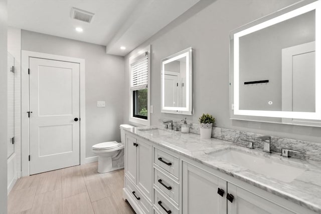 103 Warwick Rd Unit 103, Newton, MA 02465 - bathroom featuring double vanity, a shower with door, and recessed lighting
