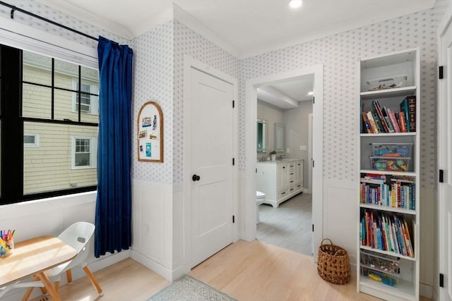 103 Warwick Rd Unit 103, Newton, MA 02465 - living area featuring wood finished floors, wallpapered walls, a wainscoted wall, and crown molding