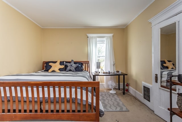 carpeted bedroom with ornamental molding