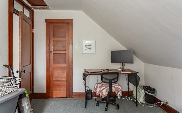 carpeted office space with vaulted ceiling