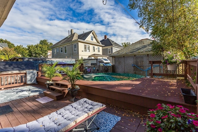 wooden deck featuring a jacuzzi